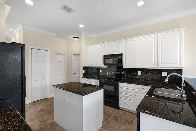 kitchen with black appliances, tasteful backsplash, a kitchen island, white cabinetry, and sink