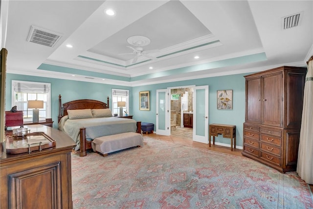 2410 47th Ter, Vero Beach, FL 32966 - bedroom with multiple windows, a raised ceiling, crown molding, connected bathroom, and ceiling fan
