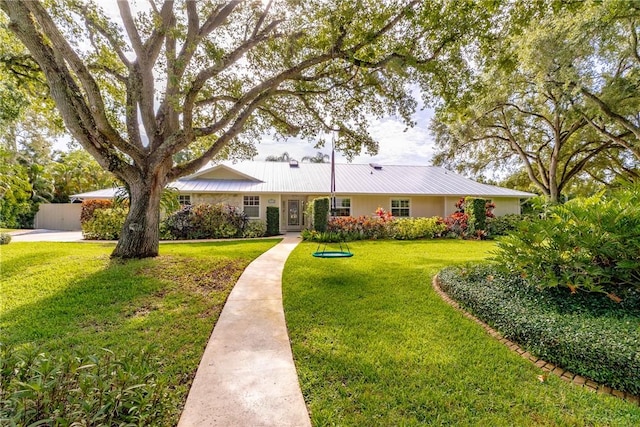2410 47th Ter, Vero Beach, FL 32966 - single story home with a front yard and a metal roof