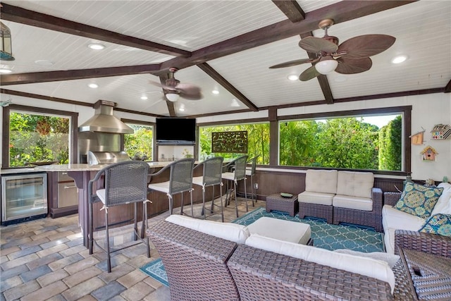2410 47th Ter, Vero Beach, FL 32966 - view of patio / terrace featuring wine cooler, an outdoor hangout area, ceiling fan, and exterior kitchen