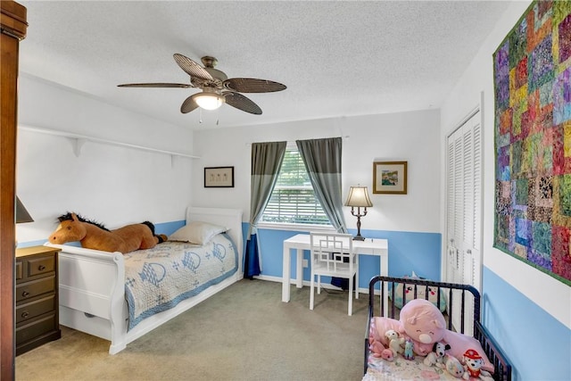 2410 47th Ter, Vero Beach, FL 32966 - bedroom featuring carpet floors, a closet, a textured ceiling, and a ceiling fan