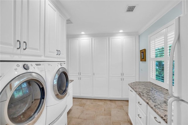 2410 47th Ter, Vero Beach, FL 32966 - laundry room featuring separate washer and dryer, stone finish flooring, recessed lighting, and cabinet space