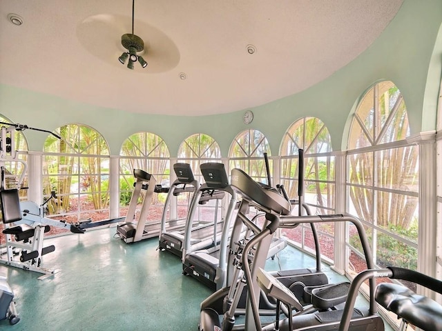 exercise room with ceiling fan