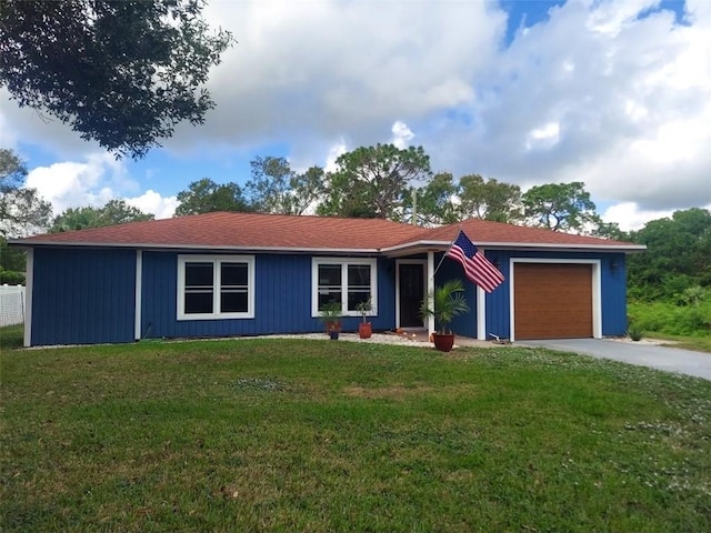 ranch-style home with a front lawn and a garage