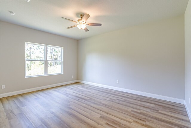 empty room featuring light hardwood / wood-style flooring and ceiling fan