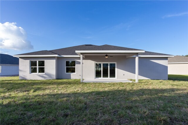 back of property featuring a patio, a lawn, and ceiling fan