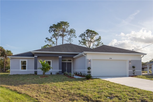 view of front of property with a garage and a front lawn