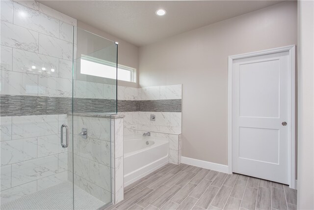 bathroom with shower with separate bathtub