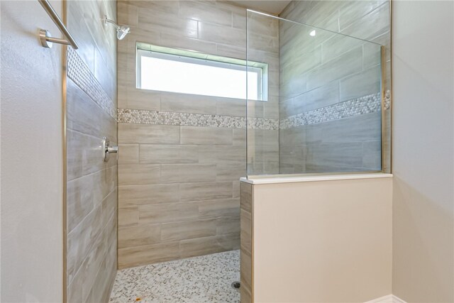 bathroom with a tile shower