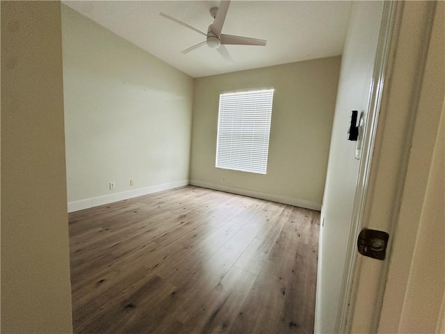6075 46th Ln, Vero Beach, FL 32967 - unfurnished room with wood finished floors, ceiling fan, baseboards, and vaulted ceiling