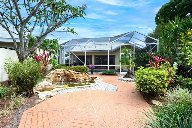 8720 Wakefield Dr, West Palm Beach, FL 33410 - rear view of property featuring a patio area and a lanai