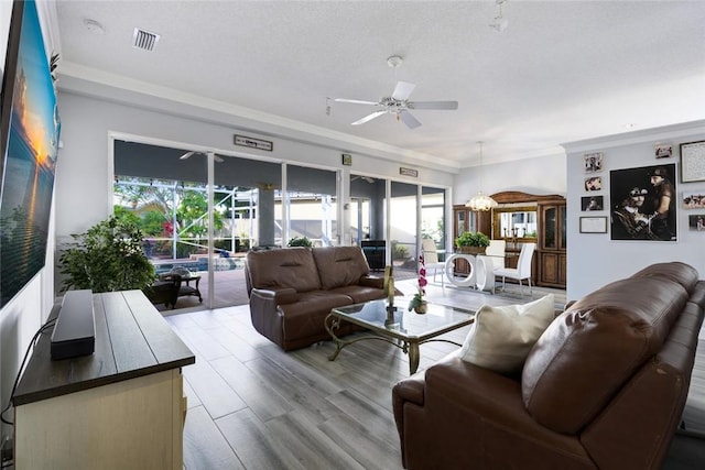 8720 Wakefield Dr, West Palm Beach, FL 33410 - living room featuring plenty of natural light, visible vents, a ceiling fan, and ornamental molding