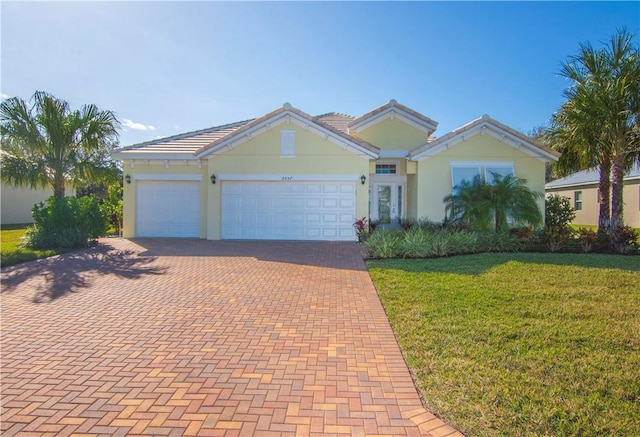 view of front facade featuring a garage and a front lawn