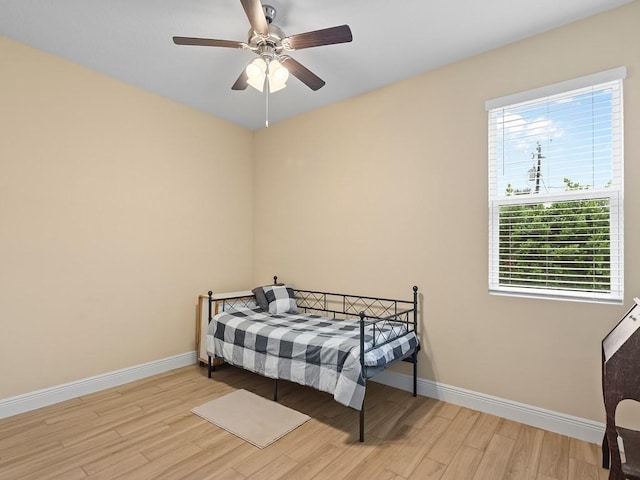 bedroom with ceiling fan and light hardwood / wood-style flooring