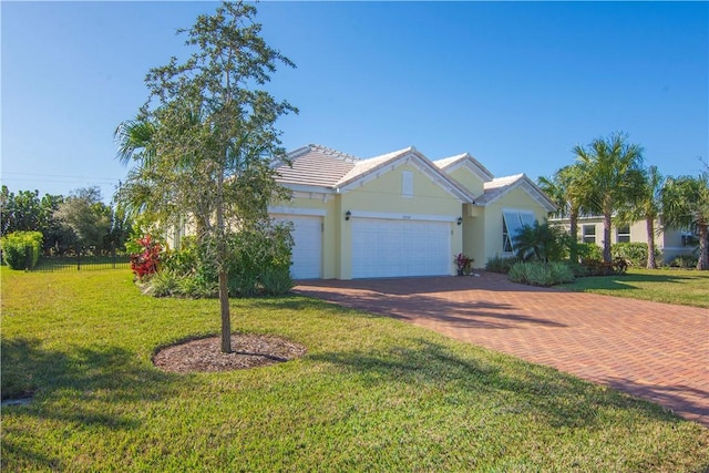 ranch-style house with a garage and a front lawn