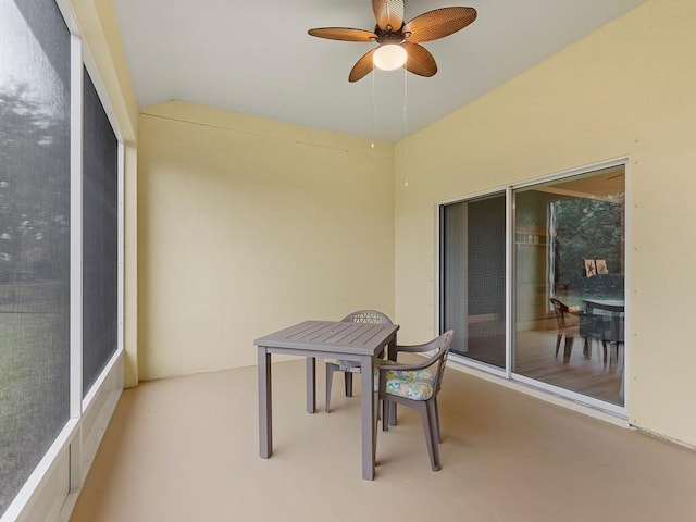 sunroom / solarium with ceiling fan and lofted ceiling