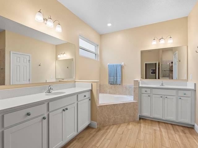 bathroom featuring vanity and shower with separate bathtub