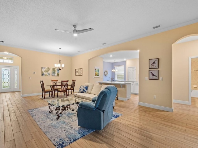 living room featuring crown molding, sink, and light wood-type flooring