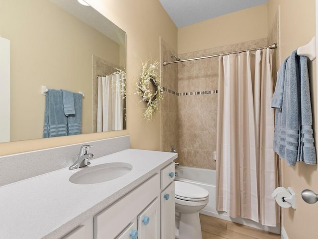 full bathroom with vanity, hardwood / wood-style floors, toilet, and shower / bath combo with shower curtain