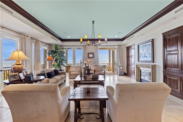 living room featuring crown molding and a notable chandelier