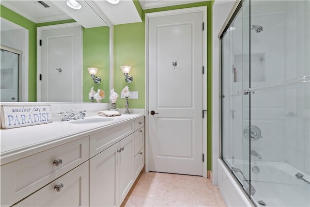 bathroom with vanity, combined bath / shower with glass door, and crown molding