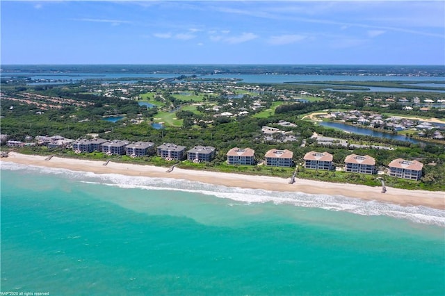 birds eye view of property with a water view and a view of the beach