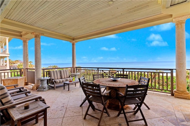 view of patio / terrace with a water view and a view of the beach