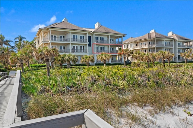 rear view of property featuring a balcony