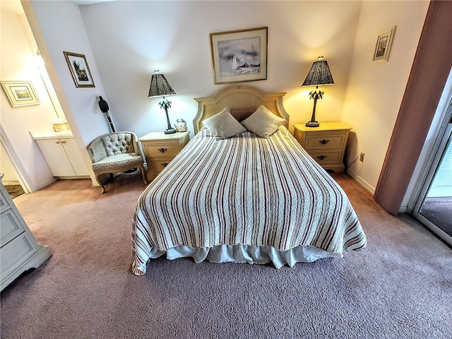 bedroom featuring light carpet and ensuite bath