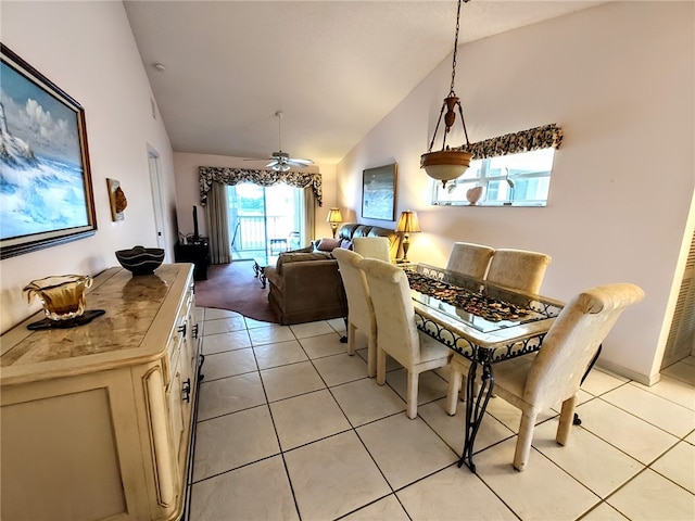 tiled dining space featuring vaulted ceiling and ceiling fan