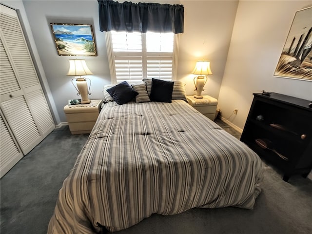 bedroom with dark carpet and a closet