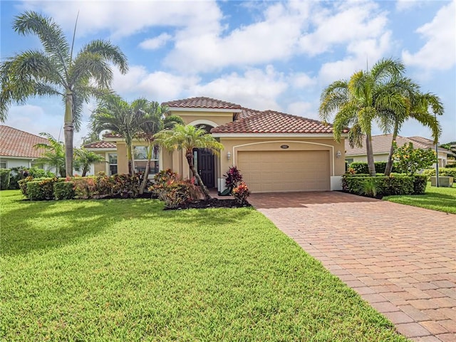 1901 Newmark Cir SW, Vero Beach, FL 32968 - mediterranean / spanish-style house featuring a garage, stucco siding, decorative driveway, a tiled roof, and a front yard