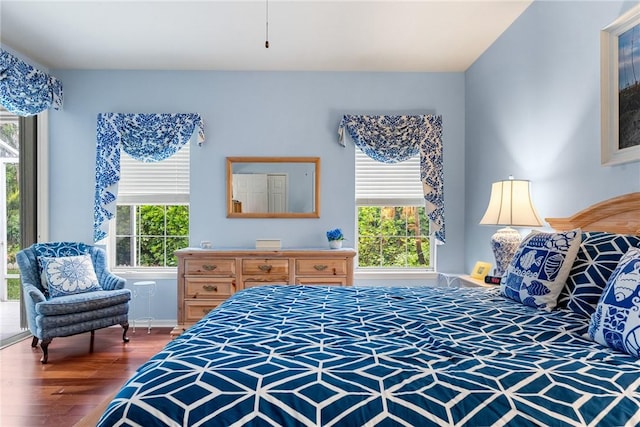 bedroom featuring hardwood / wood-style floors and multiple windows