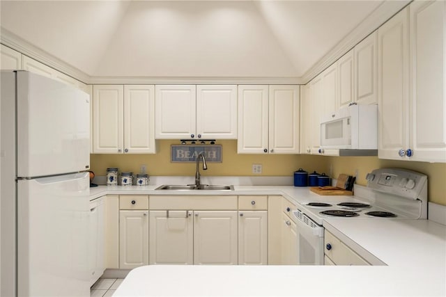 kitchen featuring sink, white appliances, white cabinetry, and vaulted ceiling