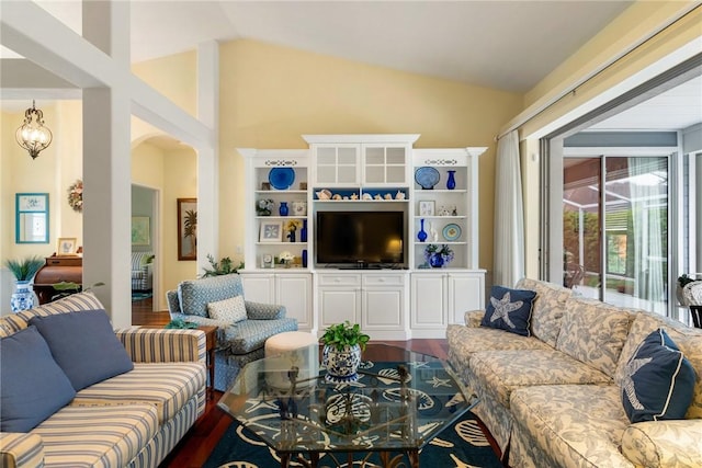 living room with lofted ceiling, wood-type flooring, and a chandelier