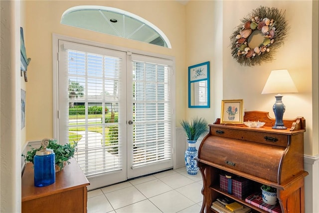 doorway with french doors and light tile patterned flooring