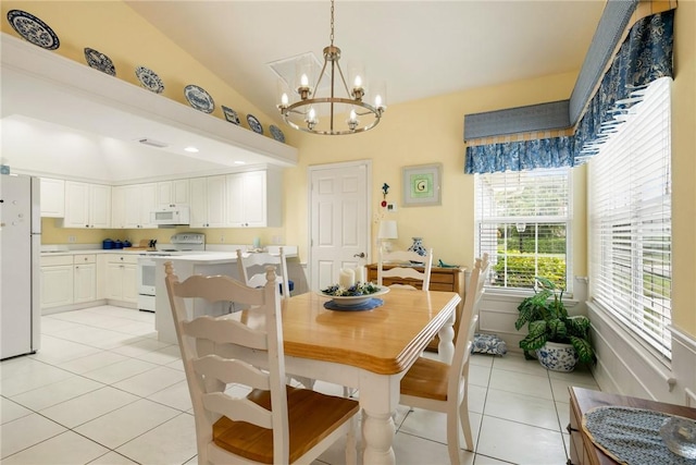 dining area with a notable chandelier, light tile patterned flooring, and vaulted ceiling