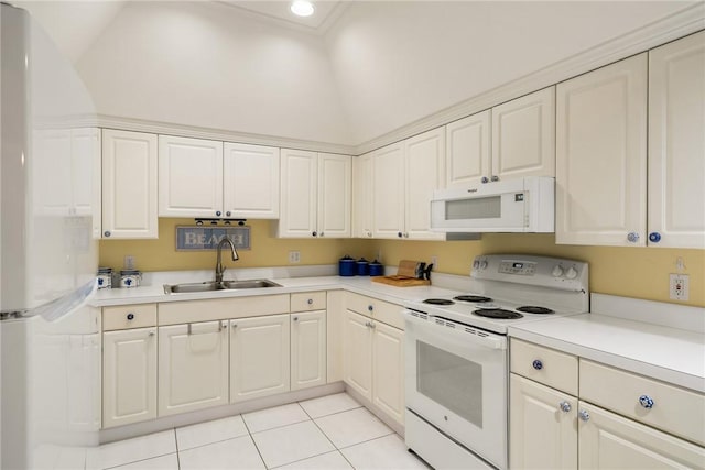 kitchen with sink, white appliances, light tile patterned floors, and white cabinets