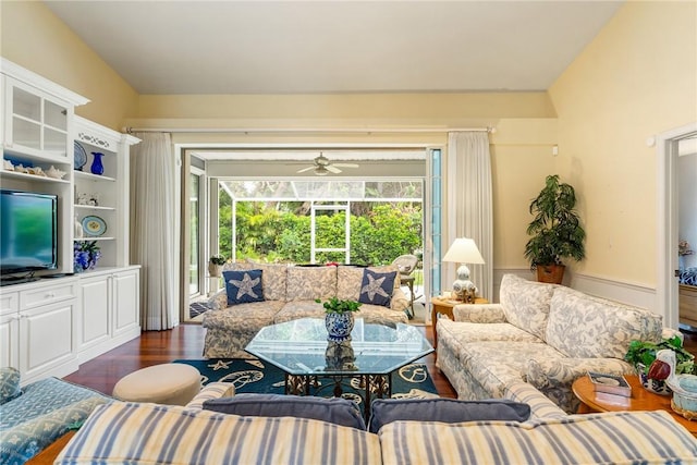 living room featuring ceiling fan and dark hardwood / wood-style floors