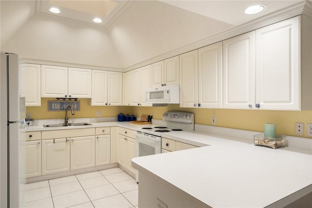 kitchen featuring white appliances, vaulted ceiling, white cabinetry, light tile patterned flooring, and sink