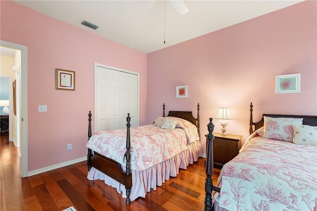 bedroom with ceiling fan, a closet, and dark hardwood / wood-style floors