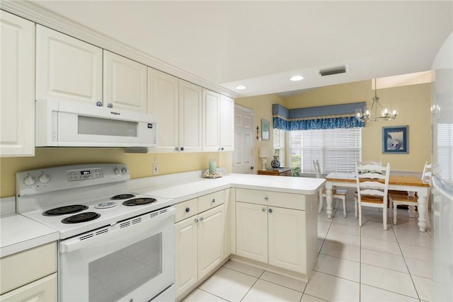 kitchen featuring white appliances, light tile patterned flooring, kitchen peninsula, a chandelier, and pendant lighting