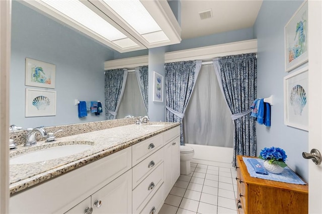 full bathroom with tile patterned flooring, shower / tub combo with curtain, vanity, and toilet