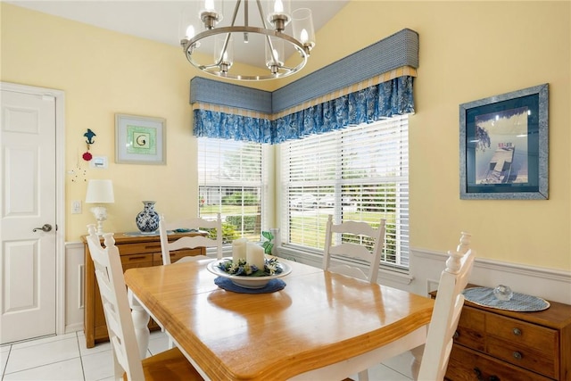 dining room featuring light tile patterned flooring and a chandelier