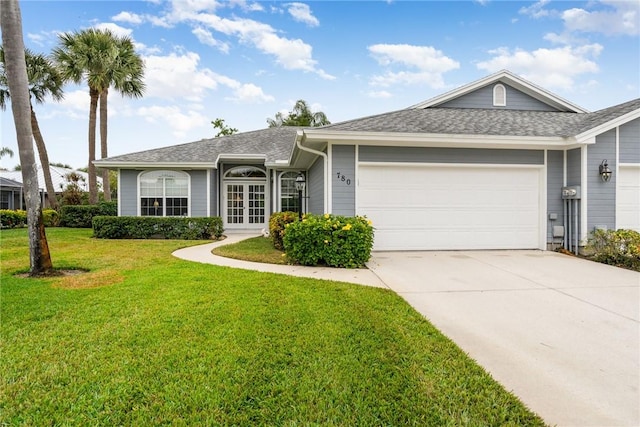 single story home featuring a front yard and a garage