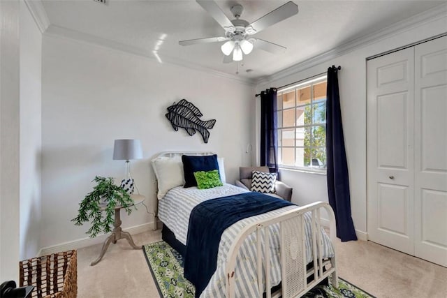 bedroom featuring a closet, carpet flooring, crown molding, and ceiling fan