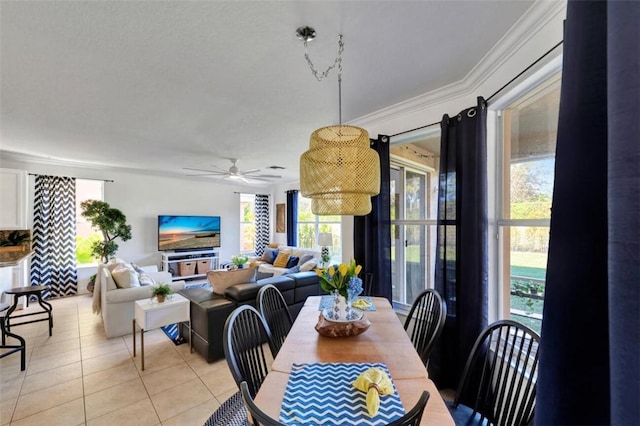 dining space with light tile patterned floors, ceiling fan, and ornamental molding