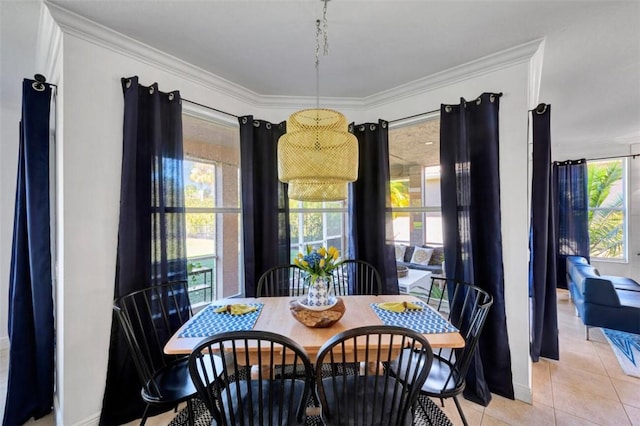 dining room featuring light tile patterned floors and ornamental molding