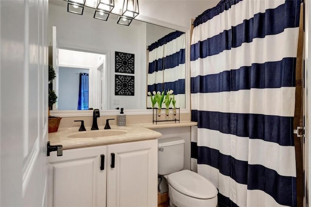 bathroom featuring vanity, toilet, and a shower with curtain