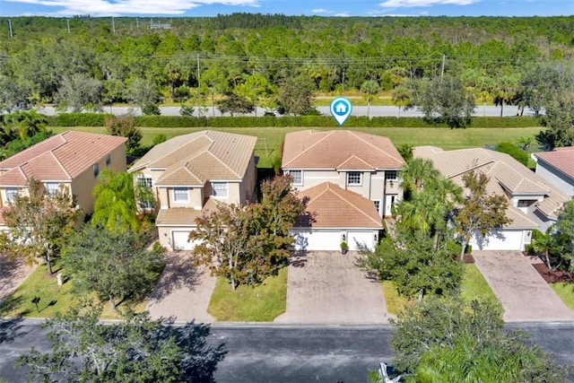 aerial view with a wooded view and a residential view